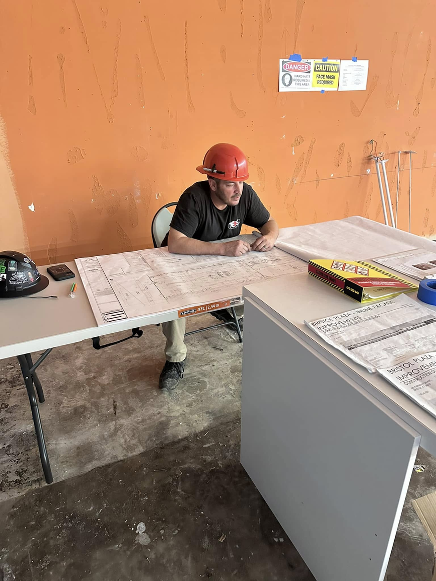 Tim Young — Owner, YES Electric, reviewing blueprints on job site